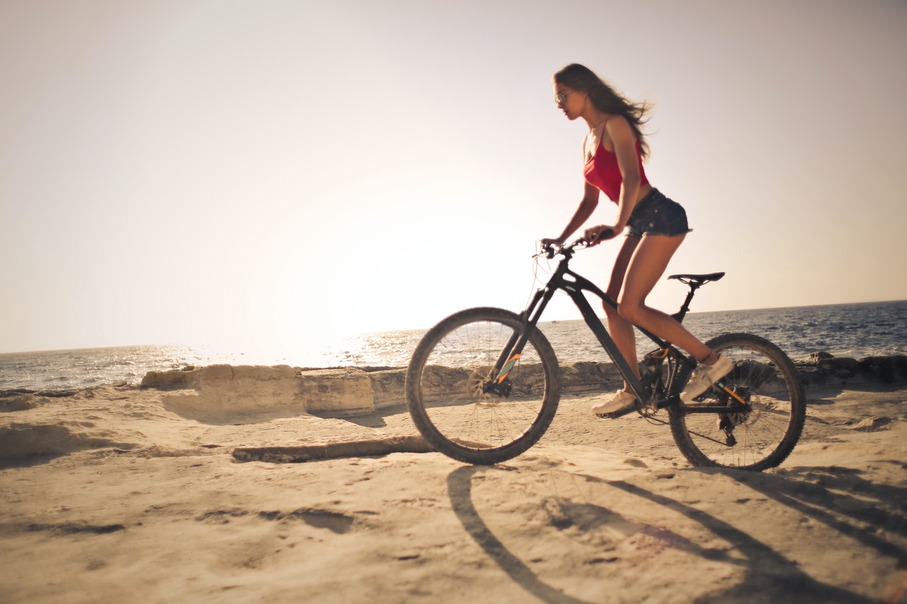 Woman riding e-bike in the sand