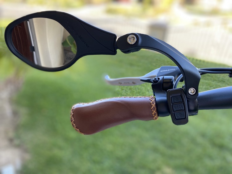 A rear-view mirror attaches to your e-bike's handlebar and makes it easier to see cars and other bicyclists to the side and behind you.