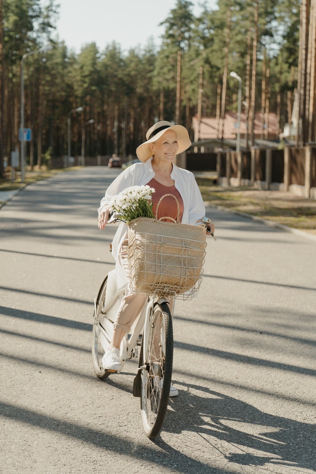 Senior woman getting exercise riding e-bike 
