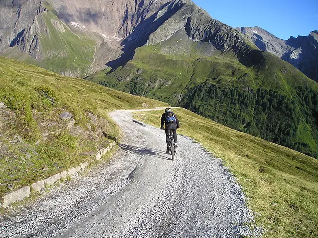 Downhill bike rider who needs to upshift so as not to go too fast downhill.