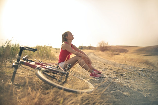 Woman enjoying fresh air and clearing her mind after a bike ride