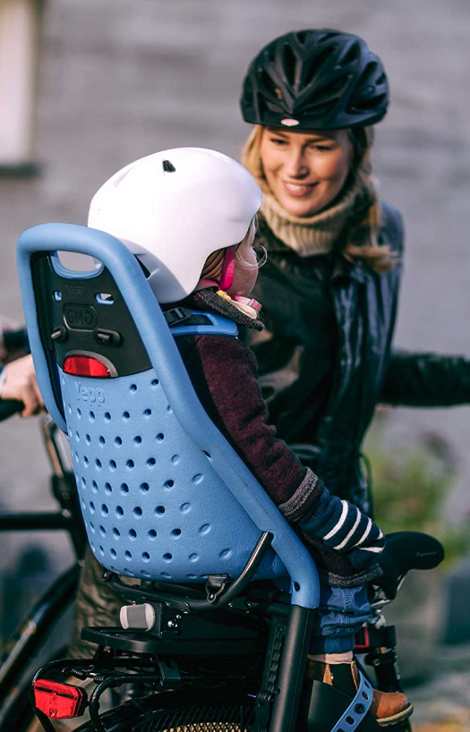 Woman putting child in bike seat
