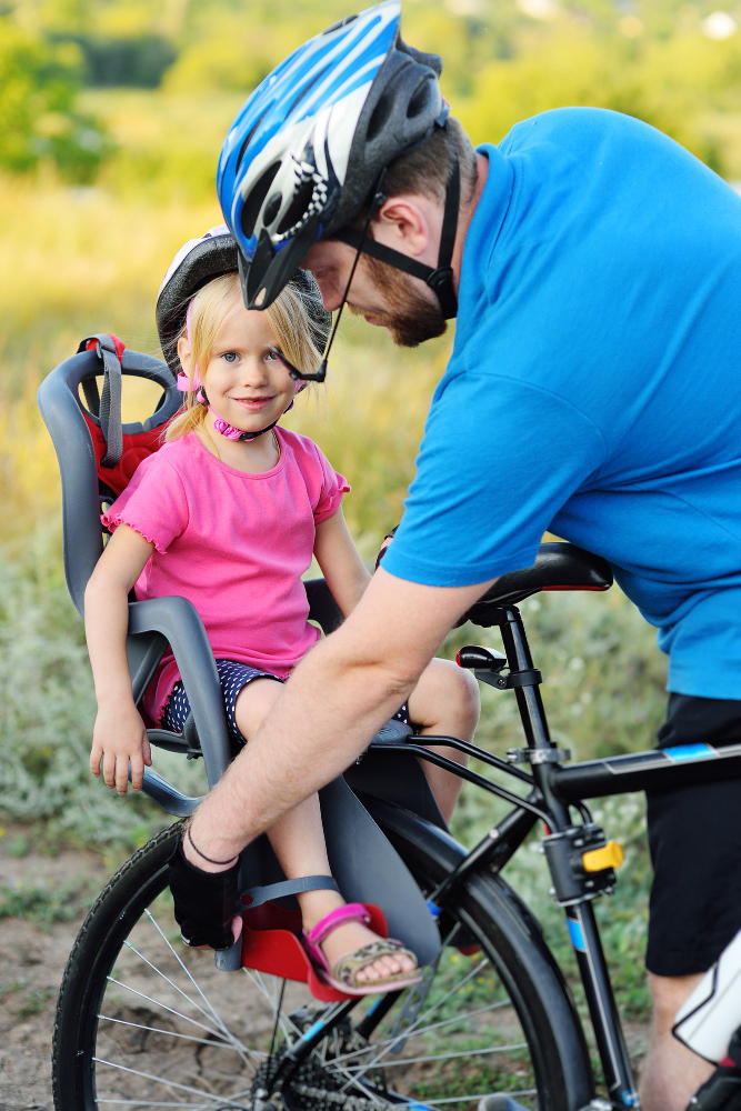 little girl riding in rear bike seat