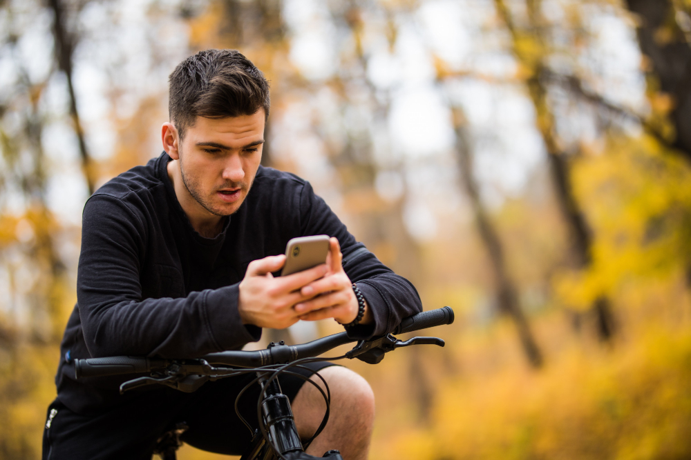 Man on electric bike using phone as gps navigation