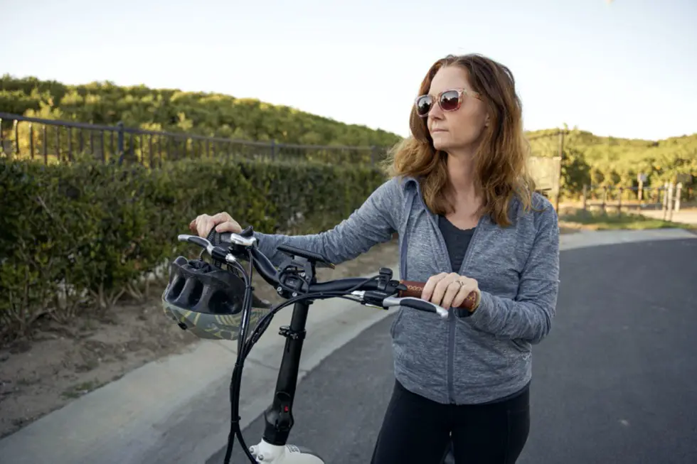 woman pushing electric bike