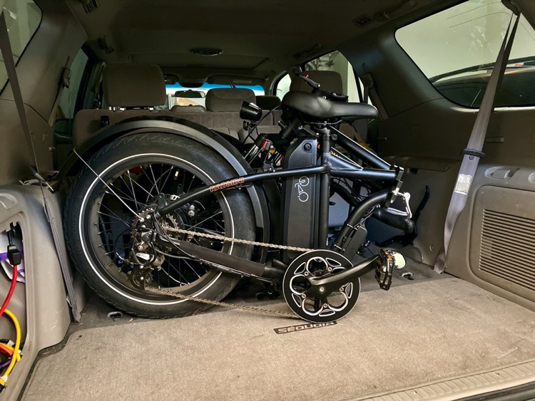 how a foldable e-bike fits in back of car