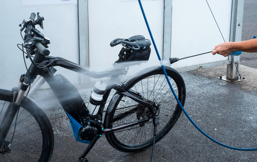 Electric bike being washed with high-pressure pump, which isn't a good idea