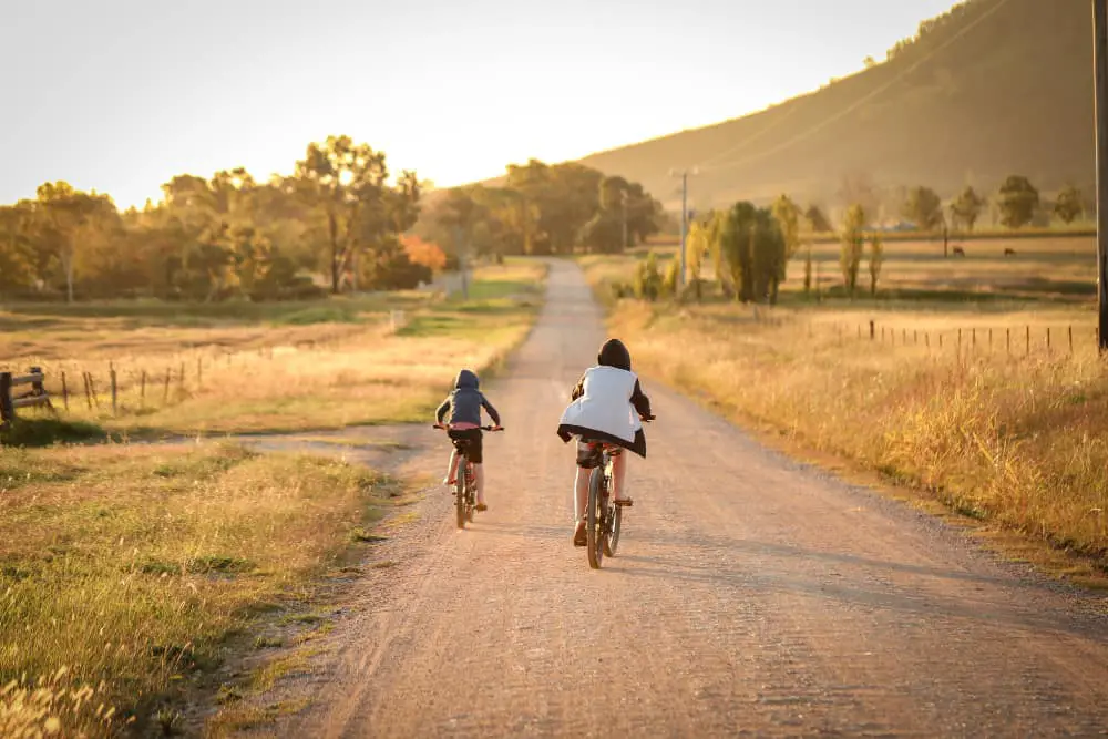 Children Riding Electric Bikes on a dirt road in the country