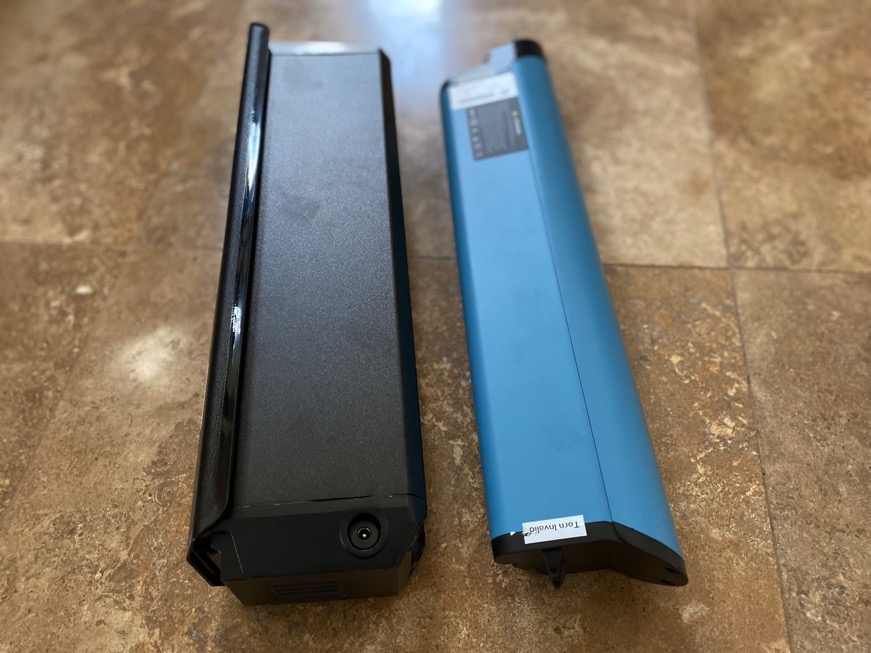 Two ebike batteries sitting sid-by-side