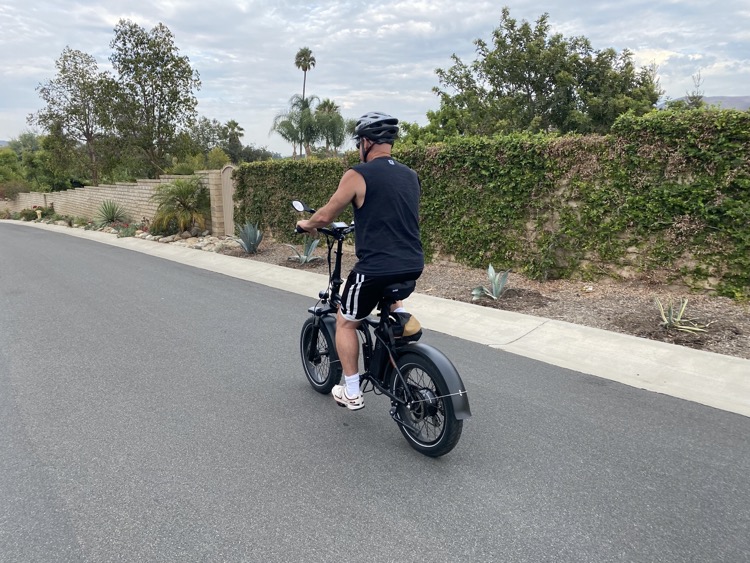 Man riding electric bike on paved road