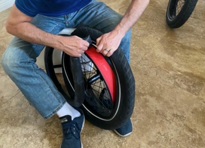 Man Replacing E-Bike Tire