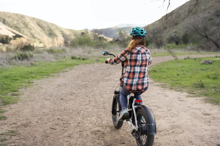 Woman Riding RadMini on dirt path