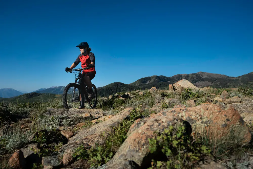 young man riding e-bike on mountain trail