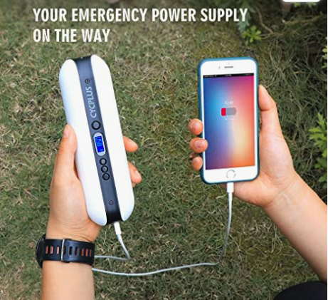 hand holding air compressor and charging phone