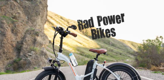 White folding Rad Power Bike with hills in the background
