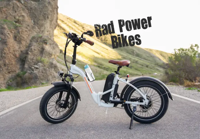 White folding Rad Power Bike with hills in the background