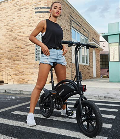 Young adult standing over ANCHEER 500W Electric Folding Bike for adults and teens