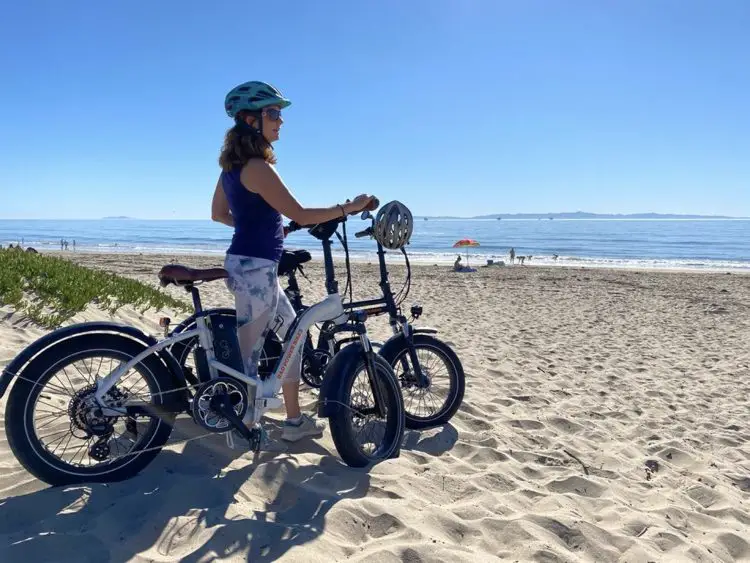 woman on beach with e-bike