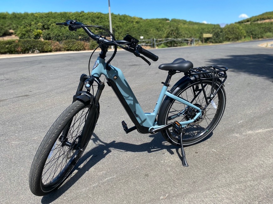 Blue E-Bike with Suspension fork sitting on street