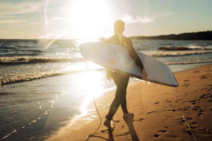 male-surfer-surfboard-wetsuit-goes-play-sports-sea