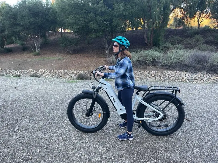 Woman standing over Haoqi Eagle Electric Fat Bike with Step-Thru Frame