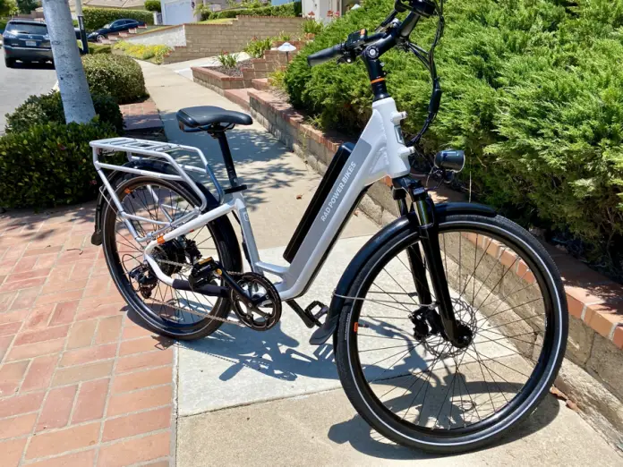 White Rad Power Bike sitting on sidewalk.