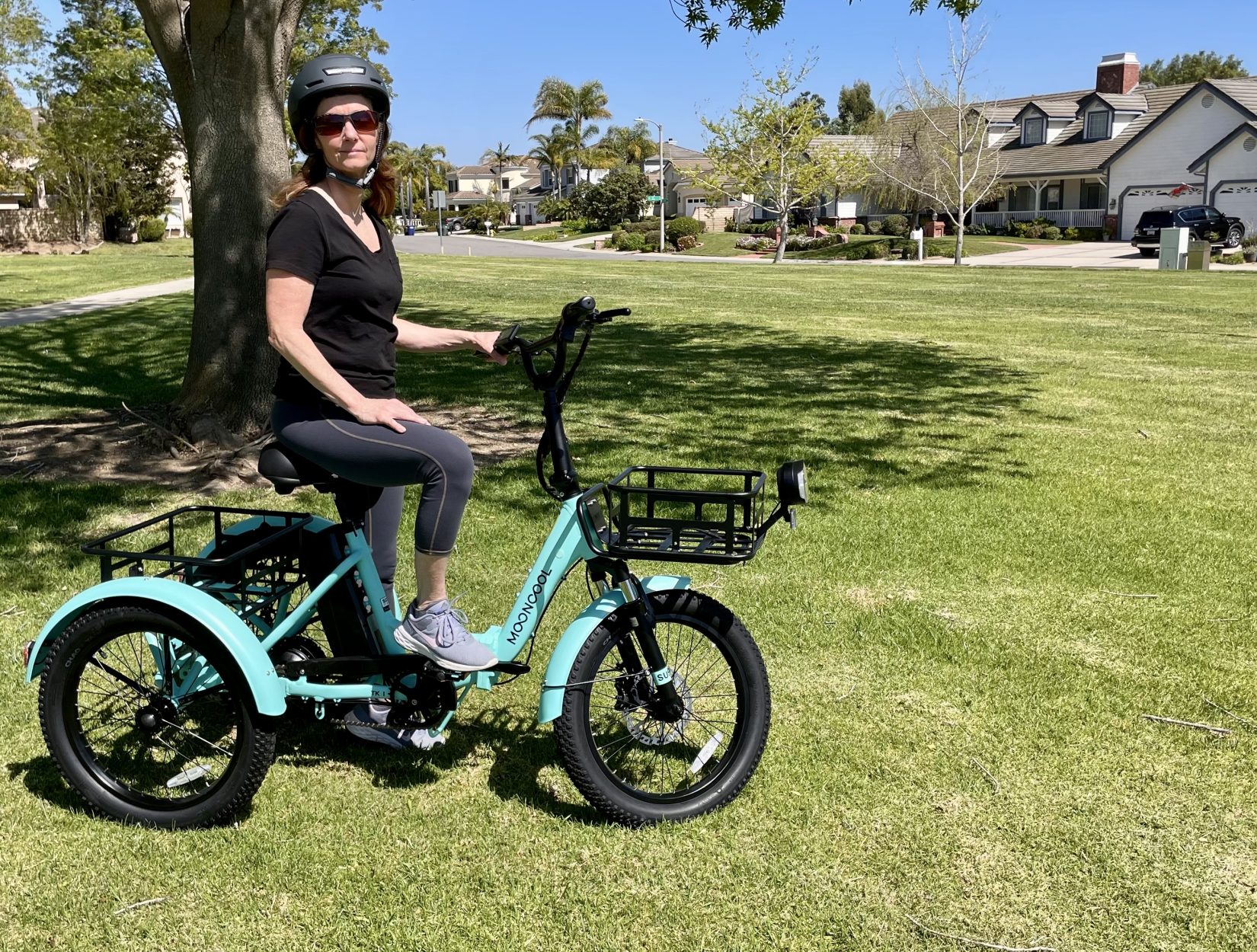 Woman sitting on electric folding trike